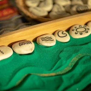 Wooden beaded threading boards on green felt for fine motor skills development at Innovative Early Learning
