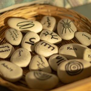 Basket of story stones with words and symbols for early learning literacy activities