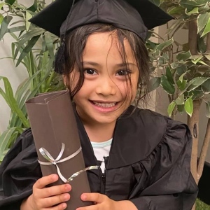 Happy child smiling in an outdoor garden setting at Innovative Early Learning childcare centre